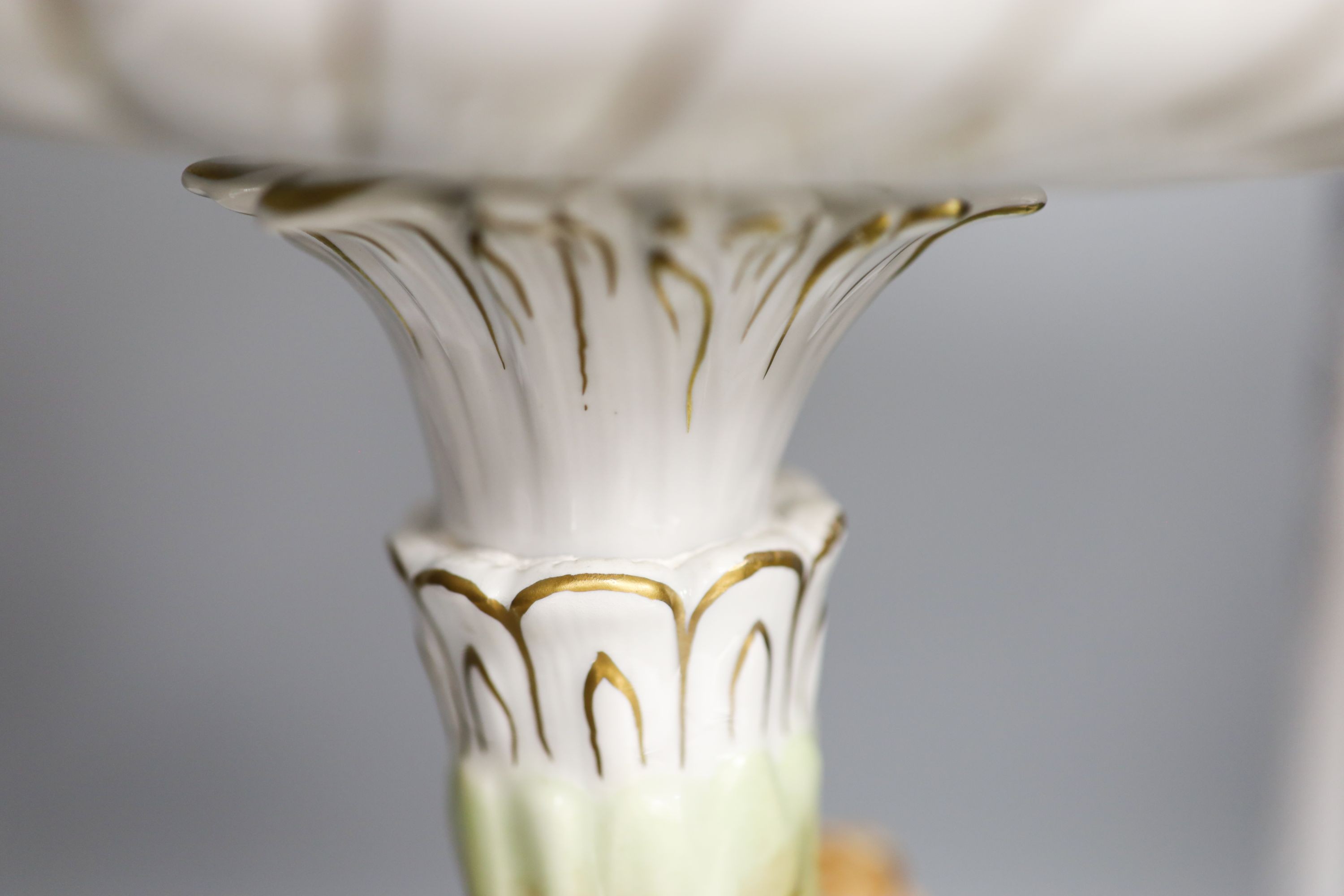 A German porcelain fruit stand, the stem decorated with four dancing figures 51cm